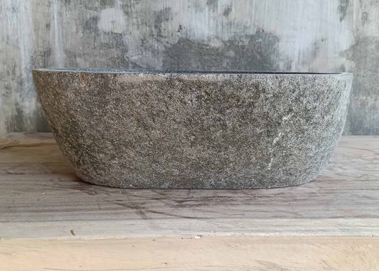 Front view showing cylindrical stone sink with natural surface
