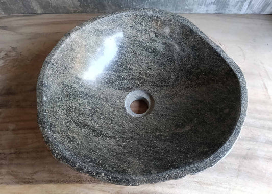 Top view of oval river stone sink in brown-gray with striped interior
