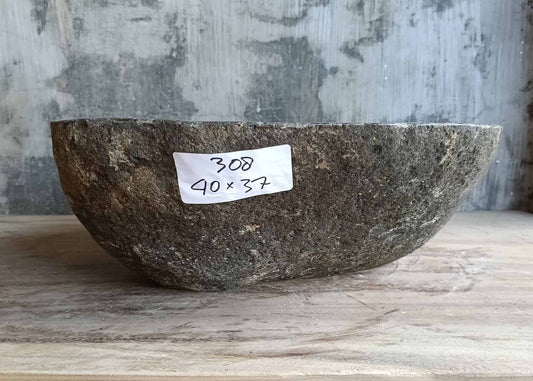 Front view of handcrafted brown-gray sink with boat-shaped form
