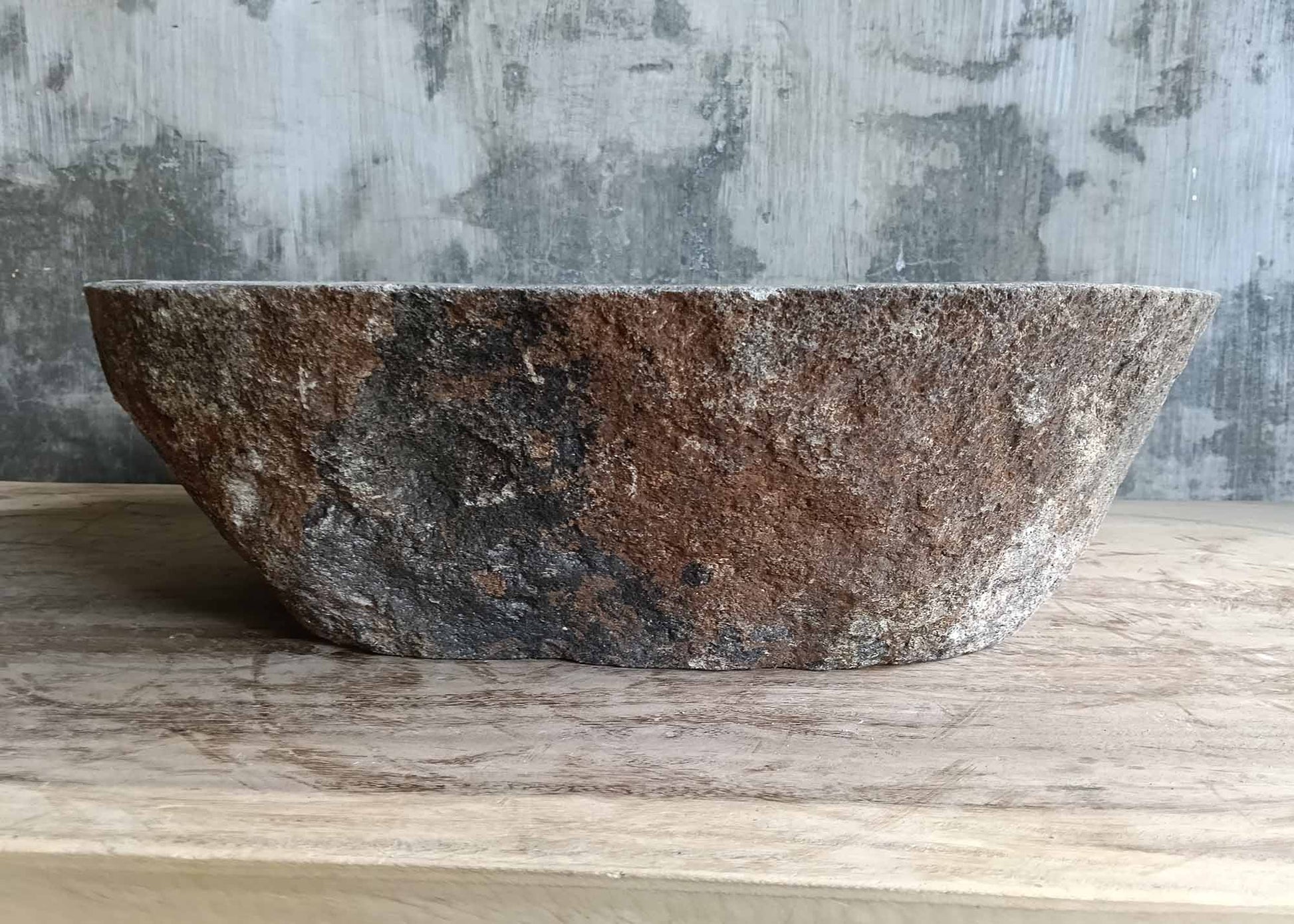 Back profile of stone sink 6309-5037 with organic oval shape and rugged exterior surface
