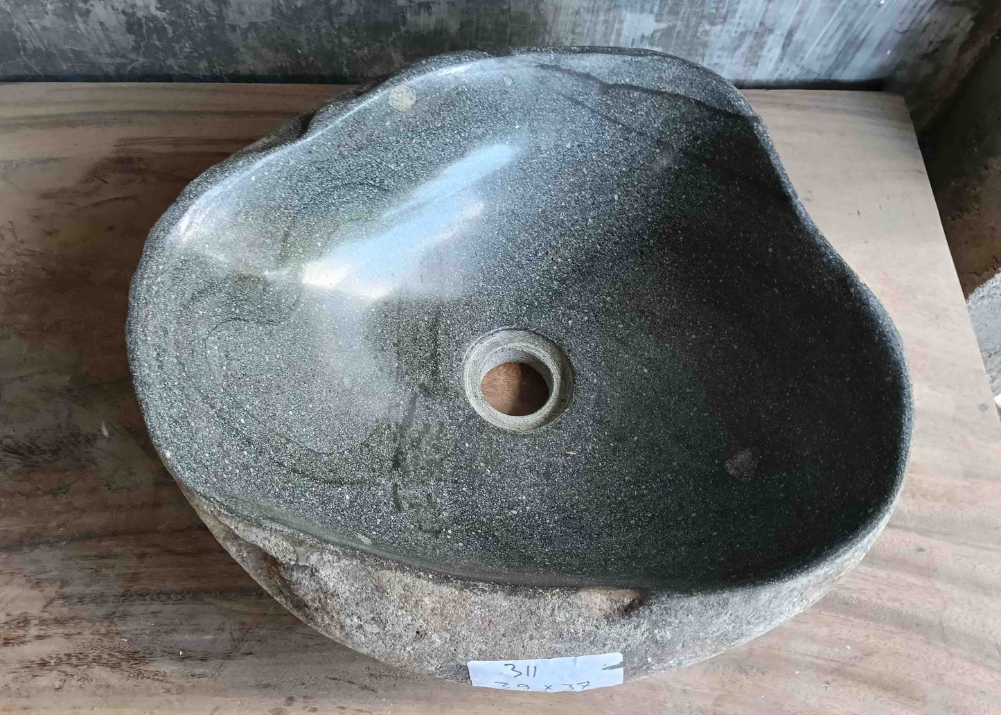 Top view of handcrafted grey 14×12 inch river stone sink in oval boat-like form
