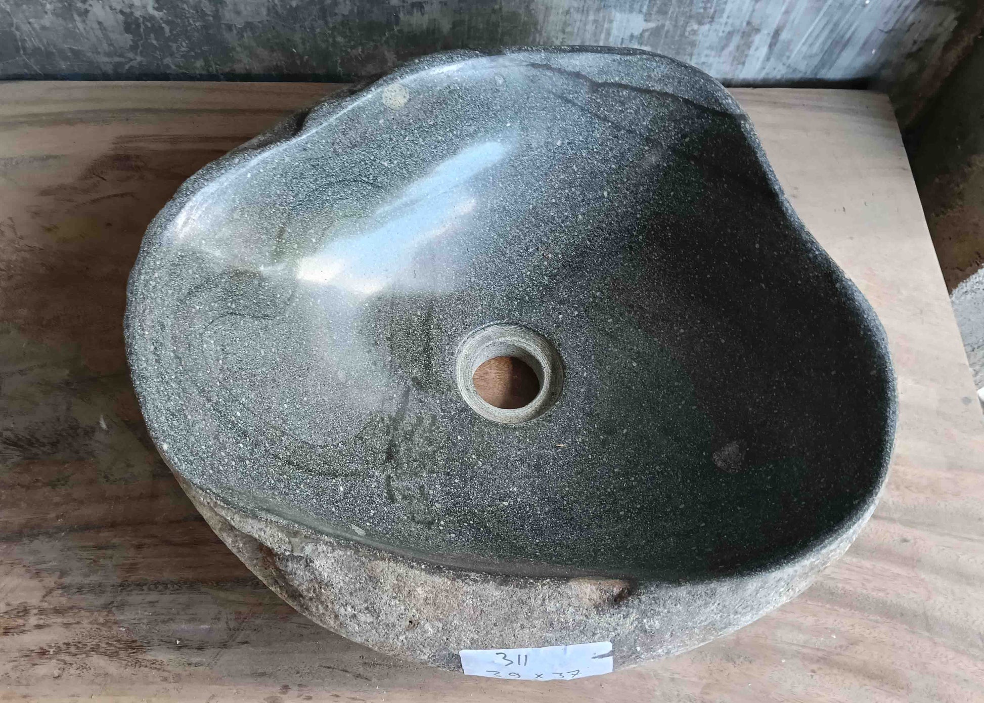 Top view of handcrafted grey 14×12 inch river stone sink in oval boat-like form
