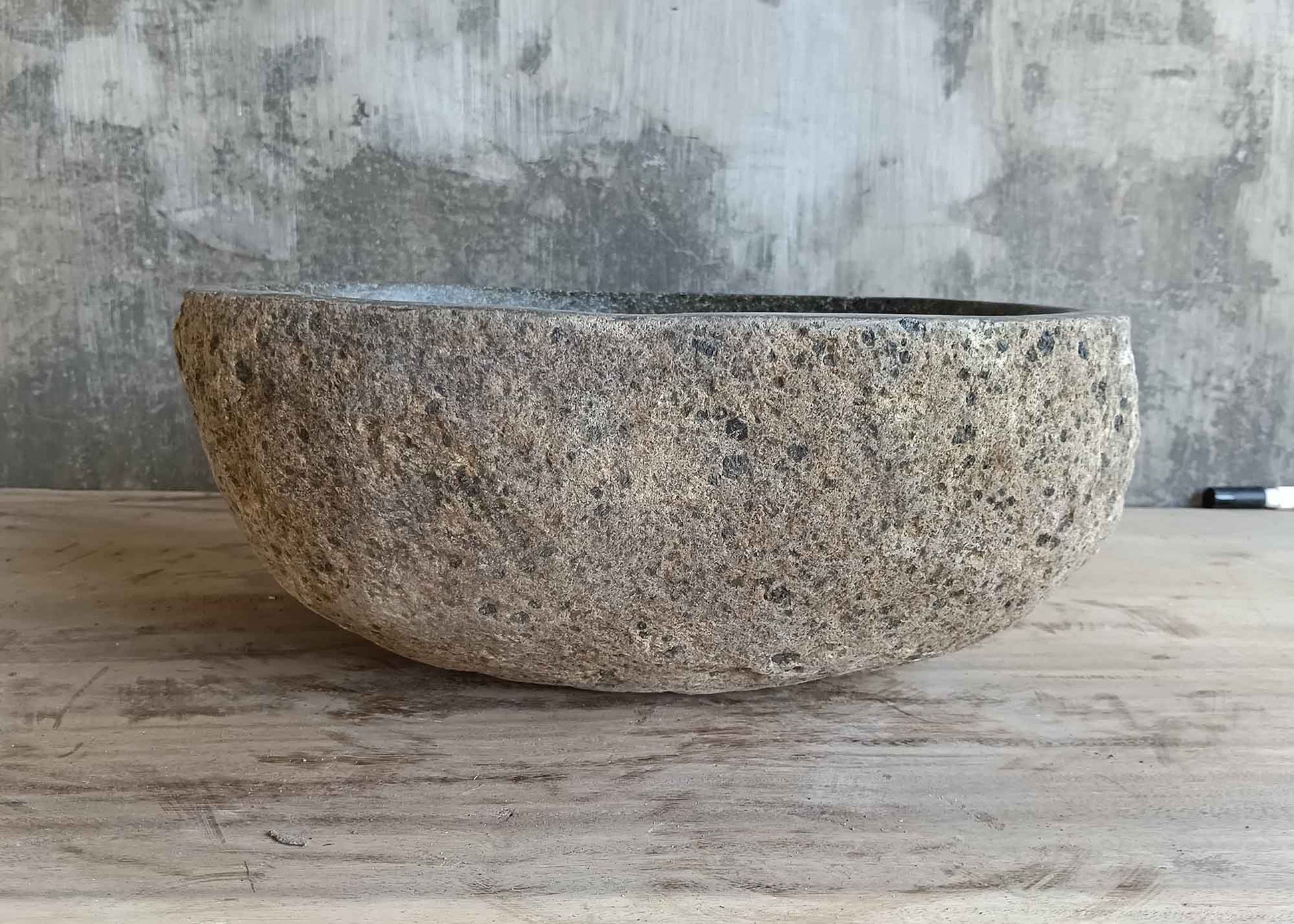 Left side view of 15×12 inch gray river stone sink in oval boat shape
