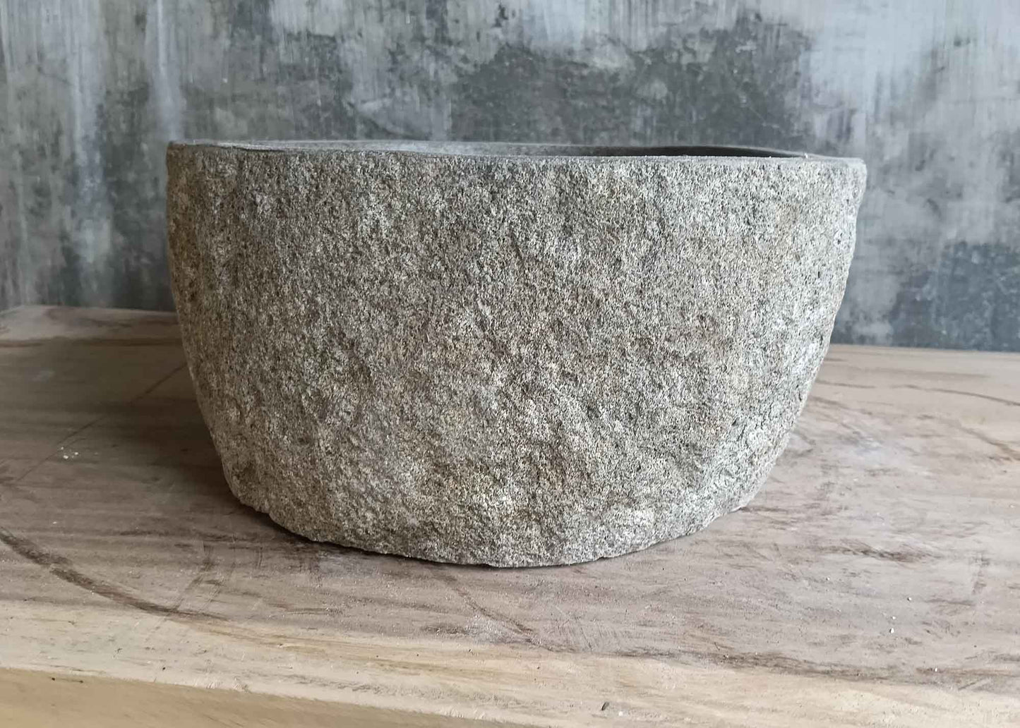 Left side view of 16×13 inch gray river stone sink in oval trapezoid shape
