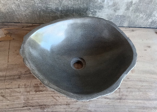 Top view of lightweight gray oval river stone sink with polished interior  
