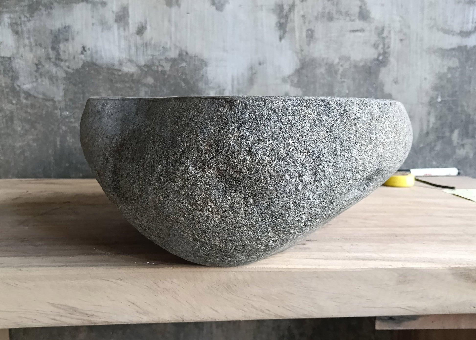 Left side of freeform river stone sink showing asymmetrical profile  

