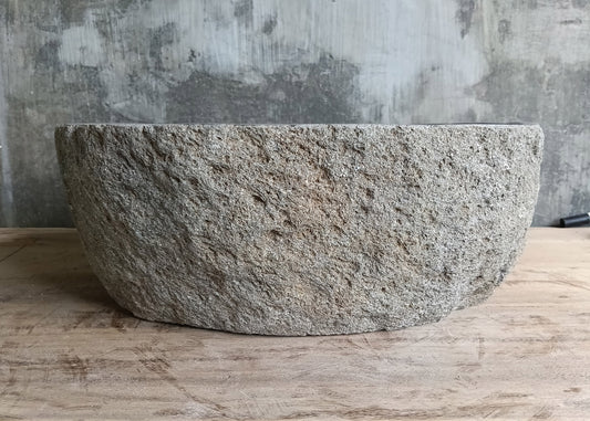 Front of lightweight oval stone sink showing smooth gray texture and boat-like shape  
