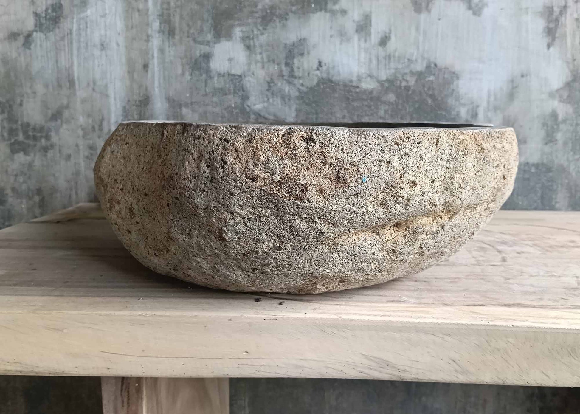 Underside of sink 6347-5845 showing organic river stone base and drain opening
