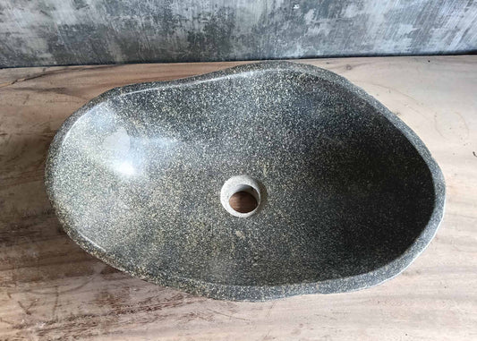 Top view of handcrafted dark gray river stone sink with polished interior  
