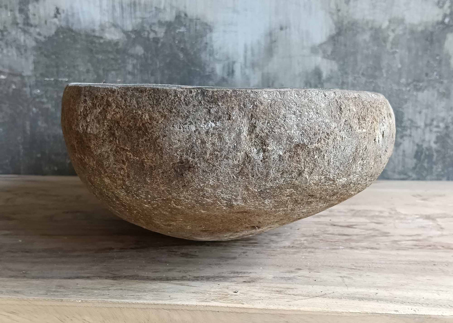 Right side of handcrafted brown-gray basin with soft asymmetry and deep stone texture  
