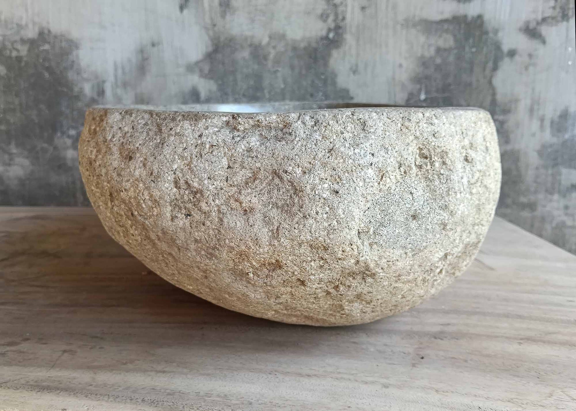 Left side of natural river stone sink with rustic organic form

