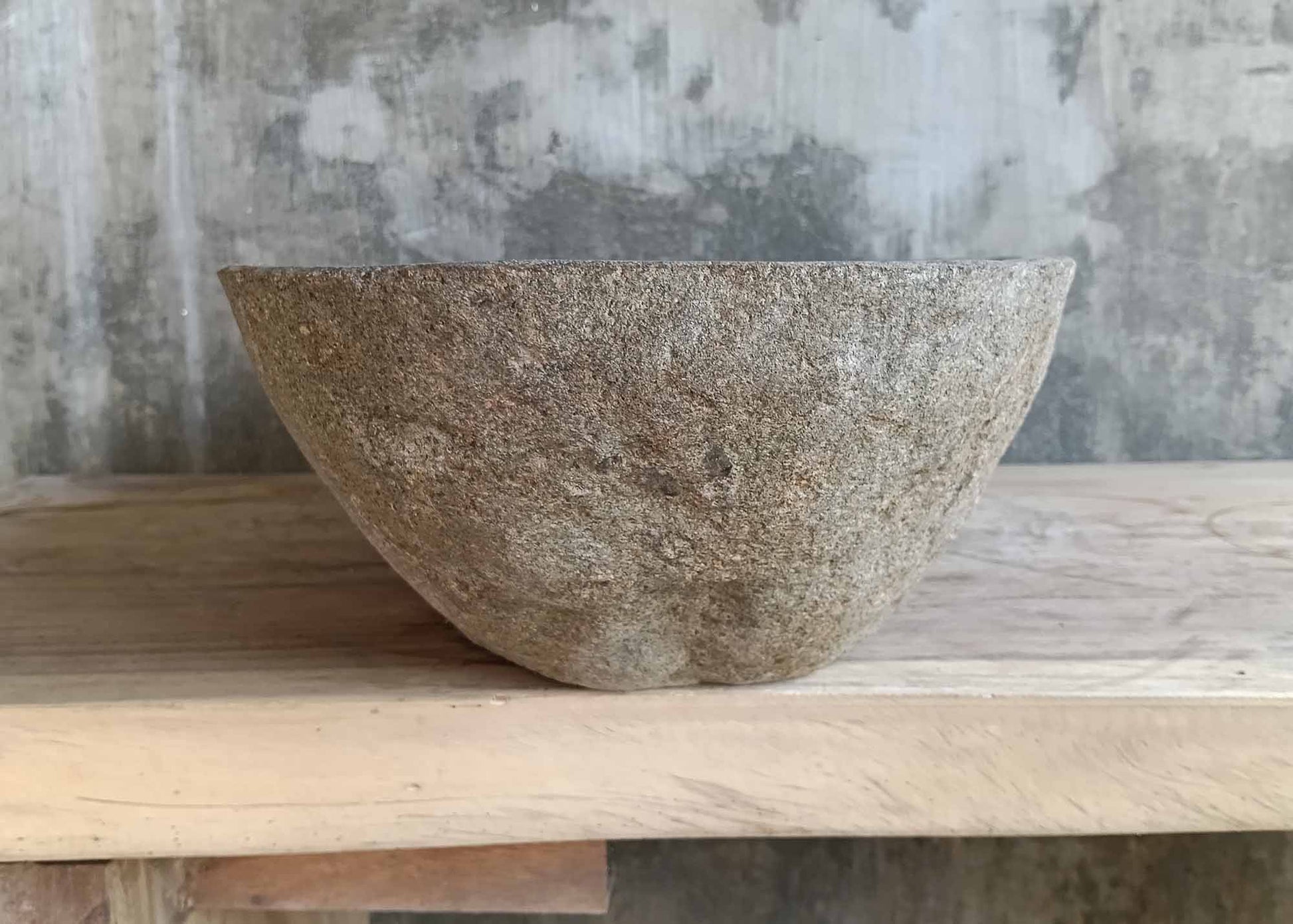 Underside of river stone sink 6373-6136 featuring raw base with drain hole
