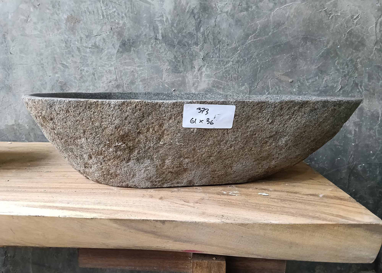 Front profile of handcrafted sink 6373-6136 with natural raw stone texture and flowing lines
