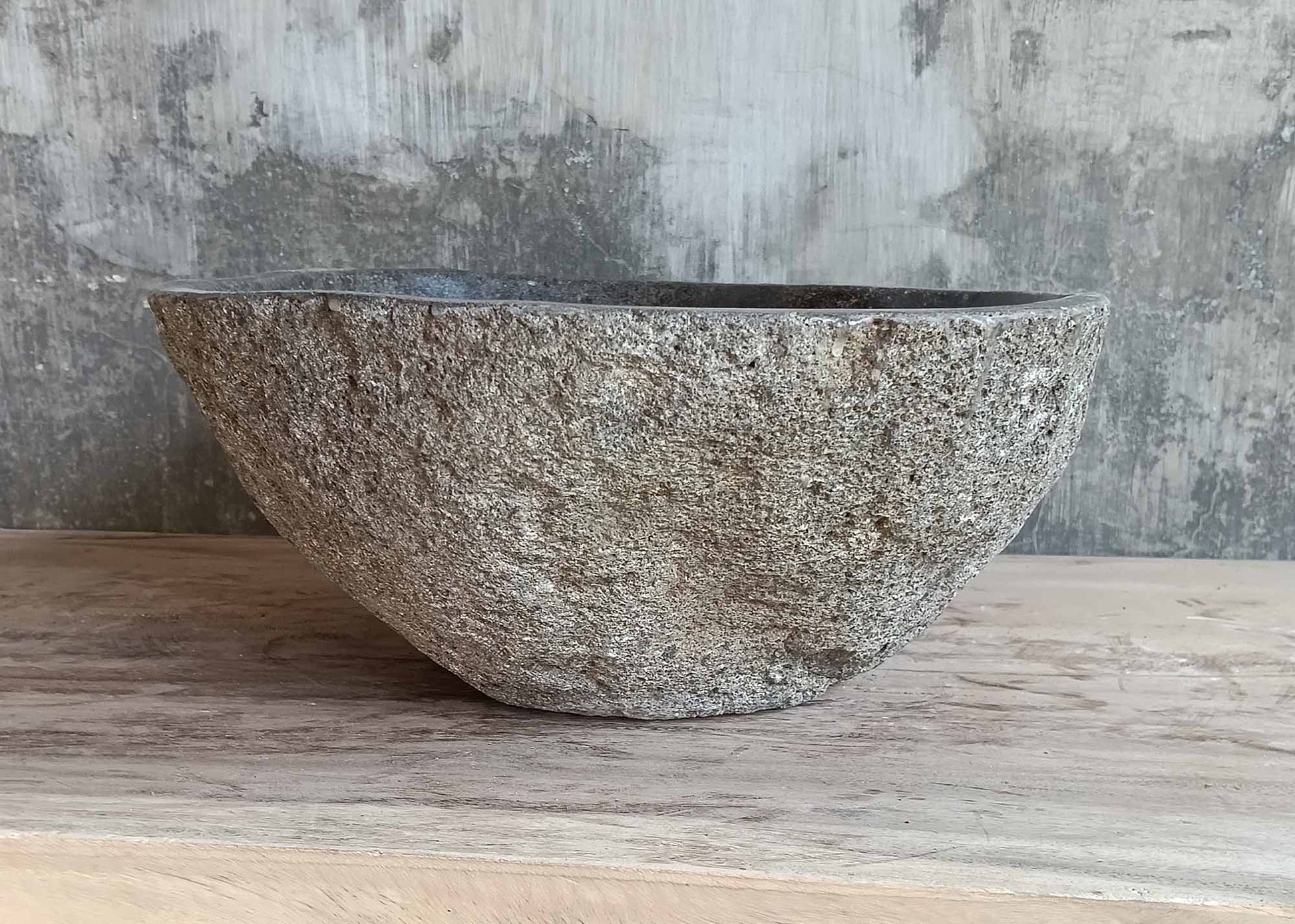 Three-quarter view showing organic oval shape and stone texture
