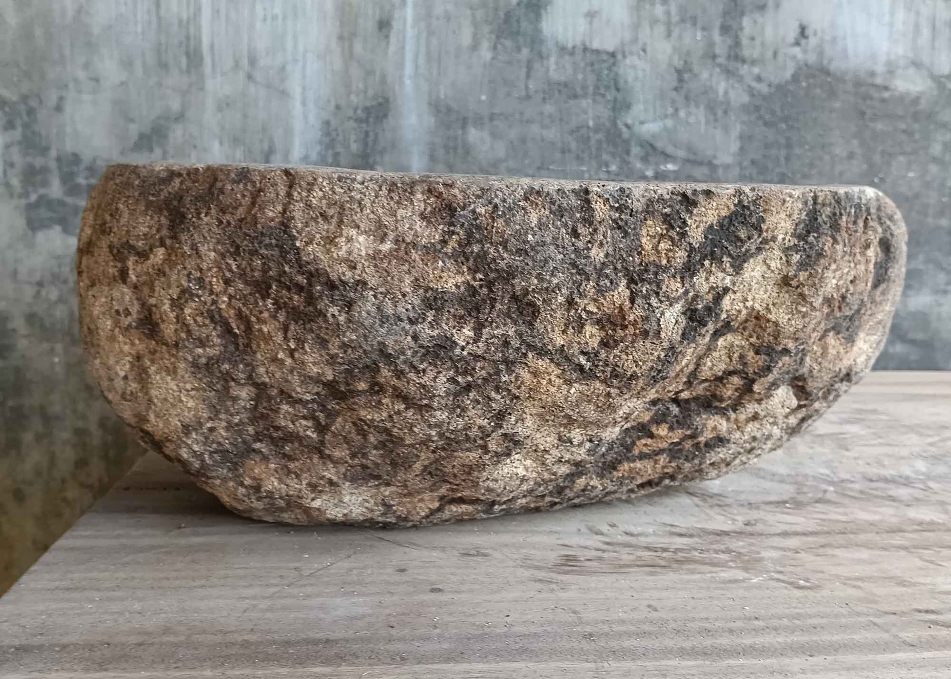 Back side view of 14×12 inch river stone sink in oval shape with light beige surface

