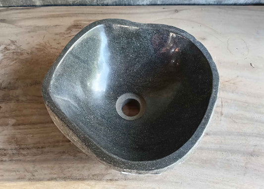 Top view of handcrafted 12×12 inch dark gray river stone sink with smooth round interior
