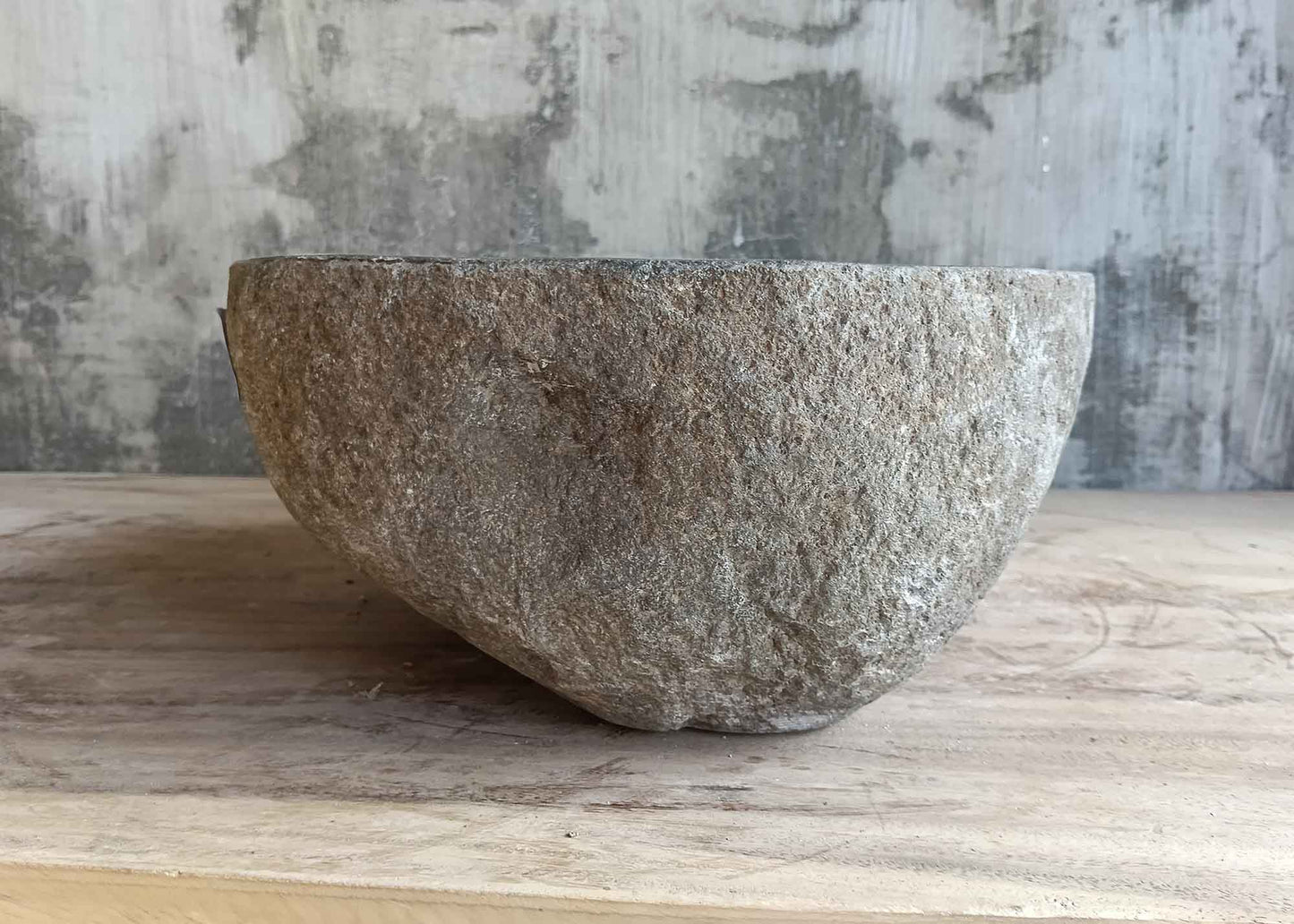 Right side view of 12×12 inch river stone sink with dark gray natural exterior
