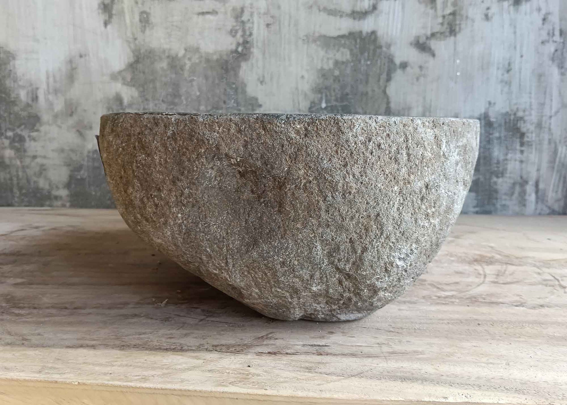 Right side view of 12×12 inch river stone sink with dark gray natural exterior
