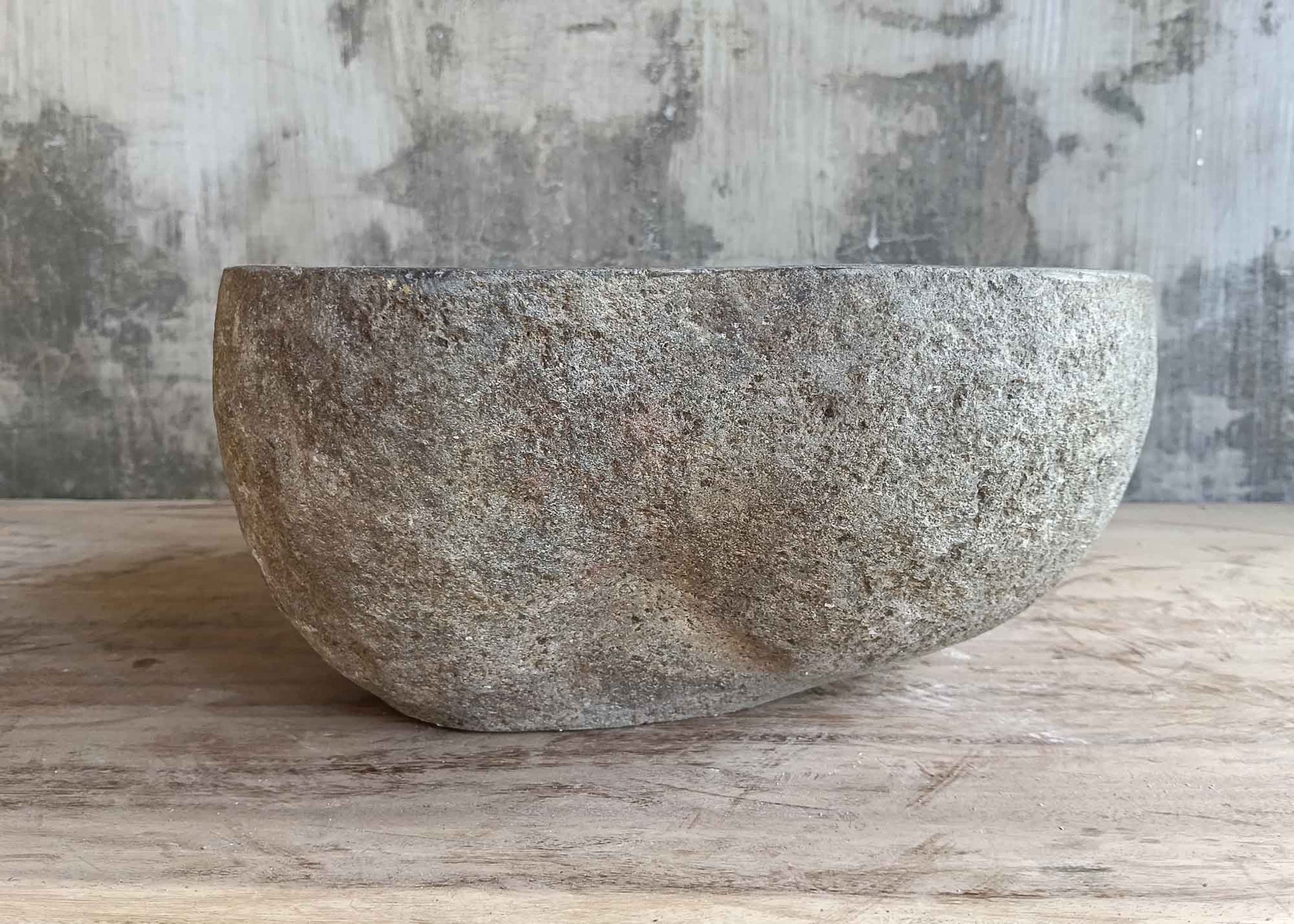 Back view of 12×12 inch round dark gray river stone sink with textured stone finish
