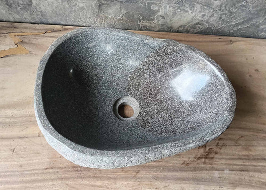 Top view of river stone sink with polished gray and silver interior
