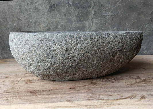 Front profile of light gray river stone sink with smooth oval shape
