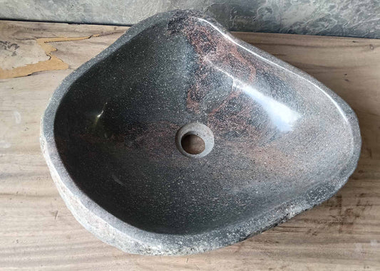Dark polished river stone sink with red streaks – top view
