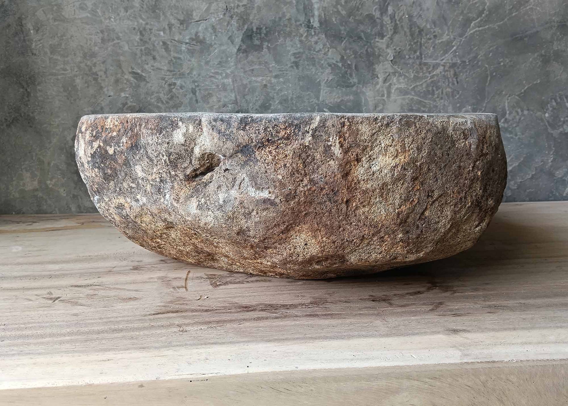 Raw textured river stone sink with earth tones – left side view
