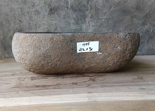 Top view of asymmetrical polished river stone sink with oval-triangle shape
