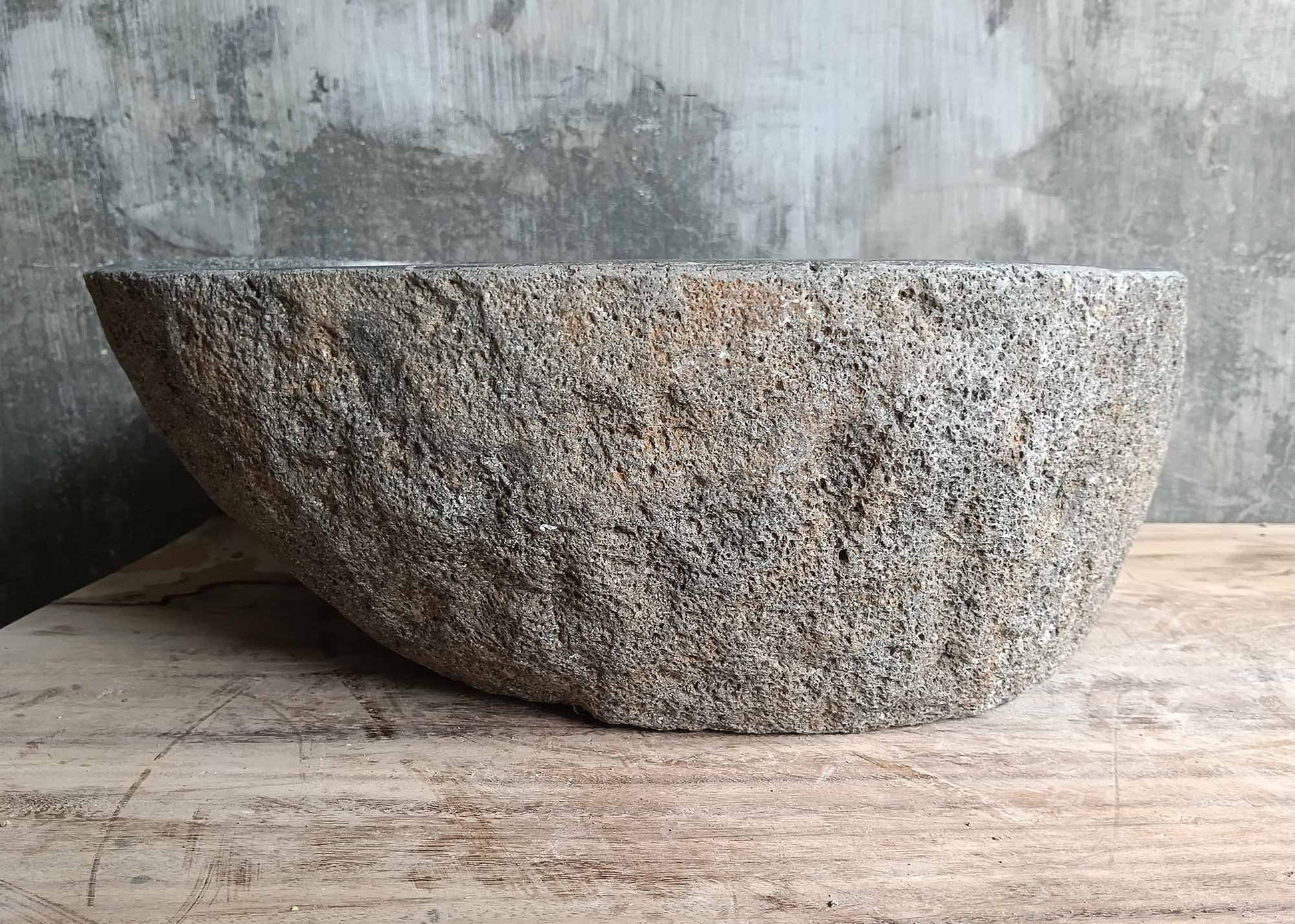Back view highlighting raw lava rock texture and natural curvature of the stone sink

