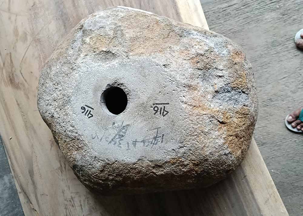 Bottom of the stone sink with flat cut surface and centered drain hole
