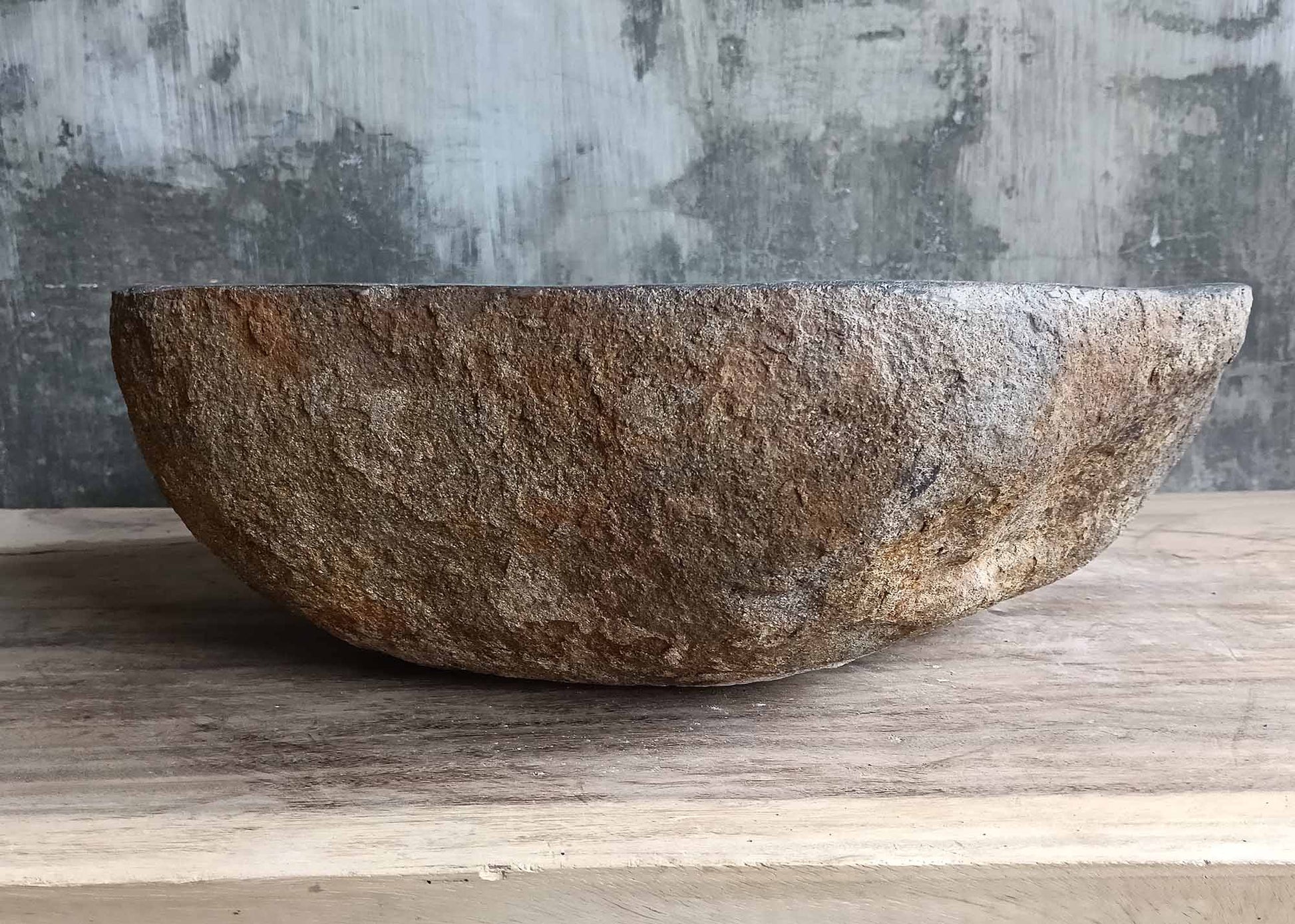 Backside of stone sink with natural texture and earthy color palette

