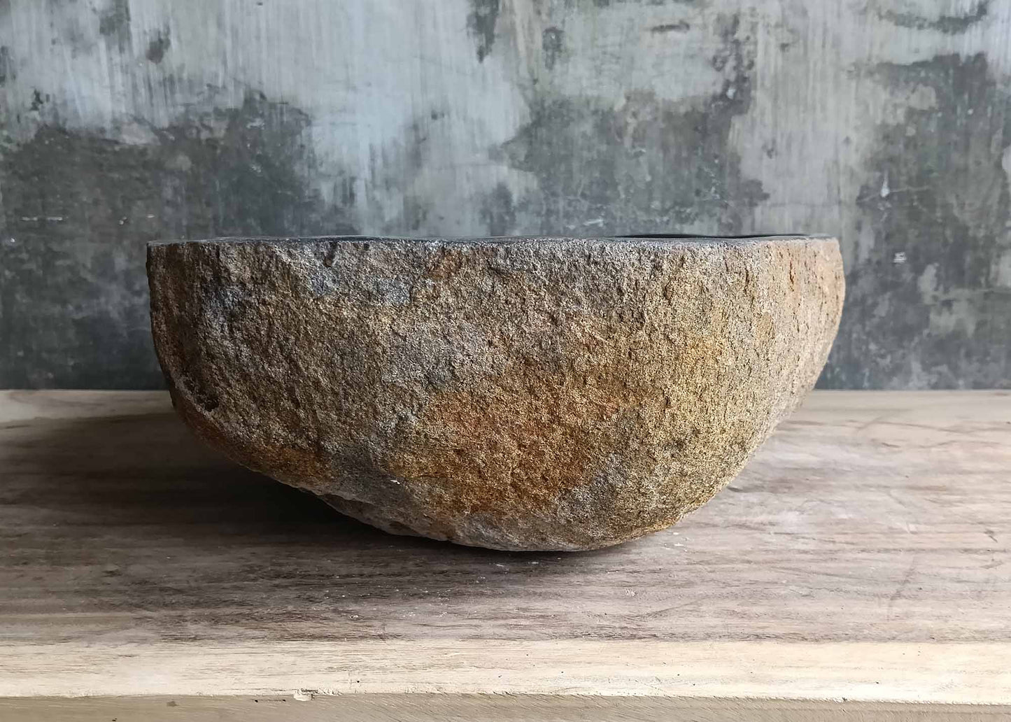 Left profile of river stone sink with rough chiseled finish
