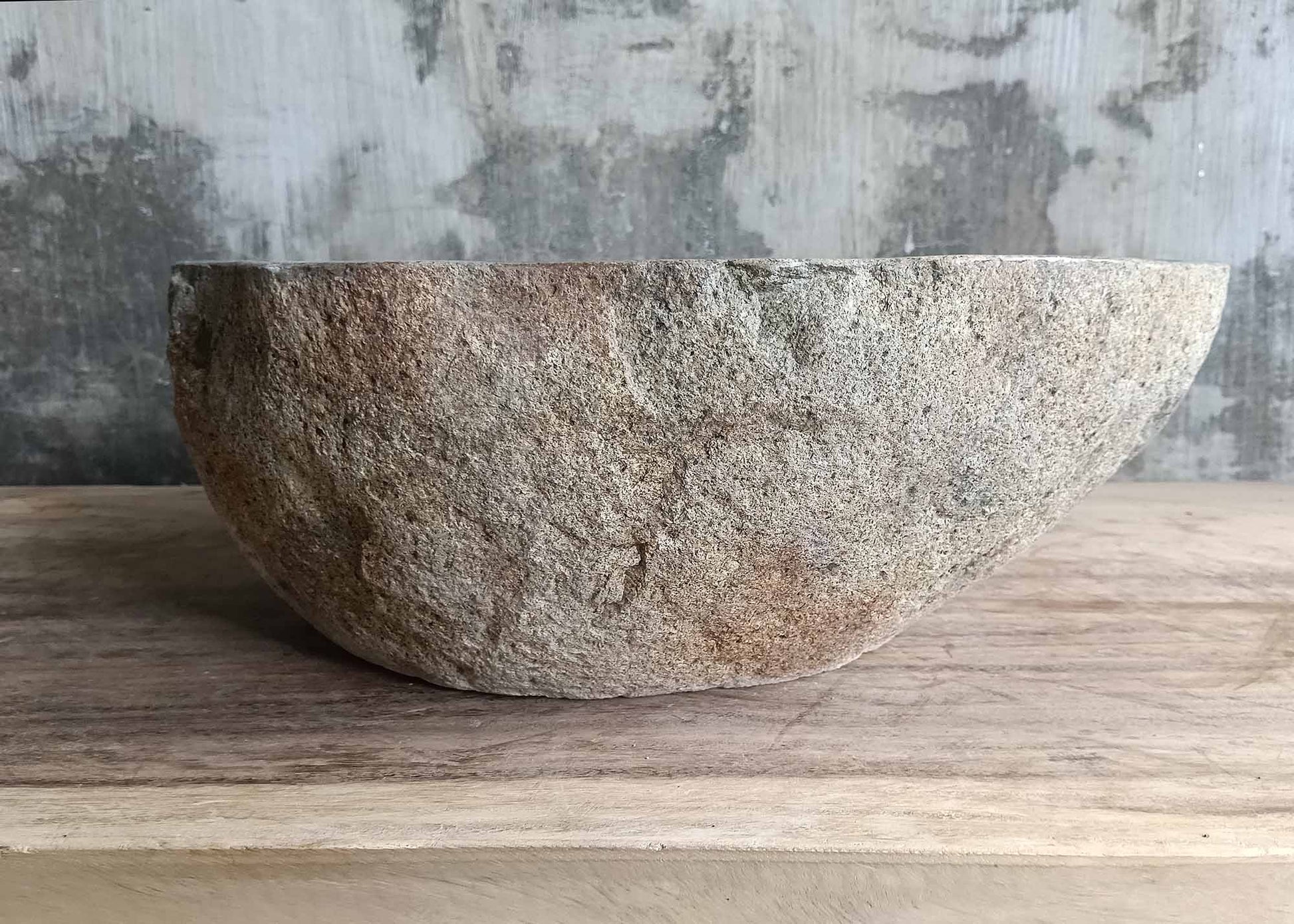 Left edge of polygonal stone sink with smooth inner contour
