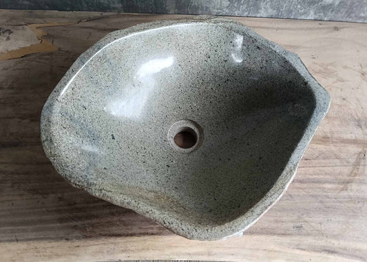 Top view of handcrafted river stone sink with polished light gray basin
