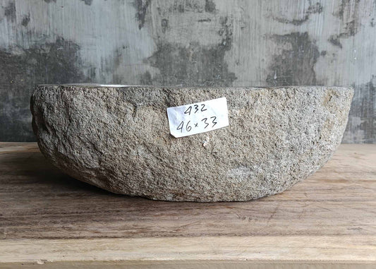 Front view of rustic river stone sink with raw natural stone texture and oval shape
