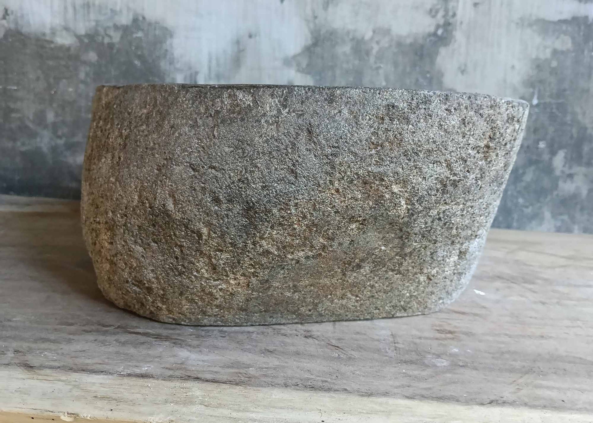 Right side of handcrafted stone sink with clean gray tones and raw texture
