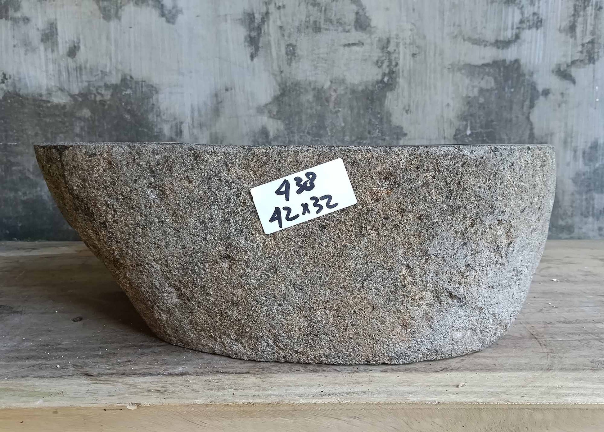 Front view showing the cylindrical profile of the gray river stone sink
