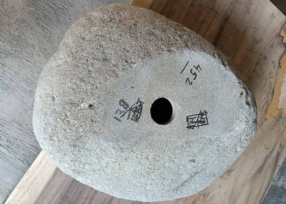 Bottom of handcrafted sink 6452-4536 showing unpolished base and drain hole
