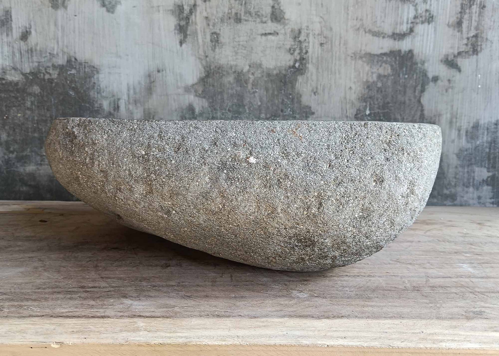 Backside of oval river stone sink 6452-4536 with raw stone finish
