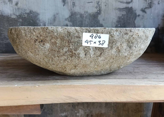 Front view of handcrafted sink 6486-4538 showing raw stone exterior and soft curves
