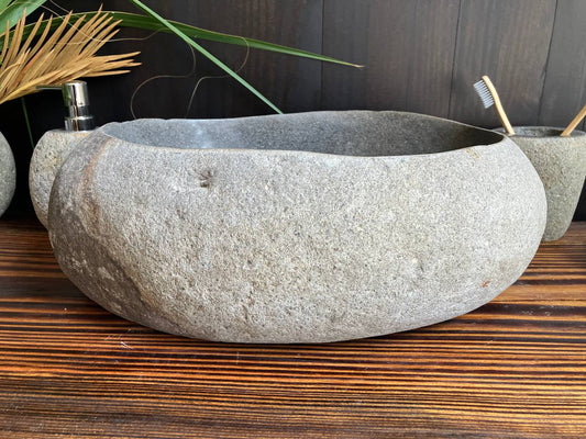 Light-gray natural river stone vessel sink RSS-009 in a bathroom vanity setting