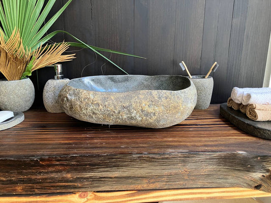 Natural rust-brown river stone vessel sink RSS-012 in a bathroom vanity setting