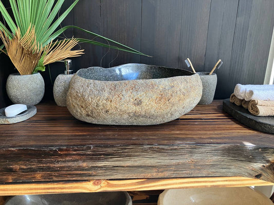 Premium reddish-brown river stone vessel sink RSS-013 in a bathroom vanity setting
