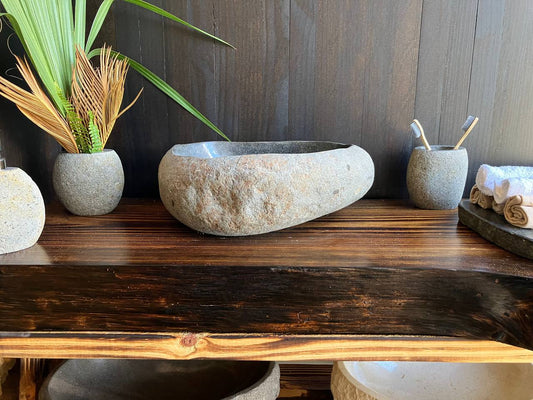 Light-gray river stone vessel sink RSS-017 in a bathroom vanity setting