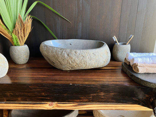 Light-gray natural river stone vessel sink RSS-021 in a bathroom vanity setting