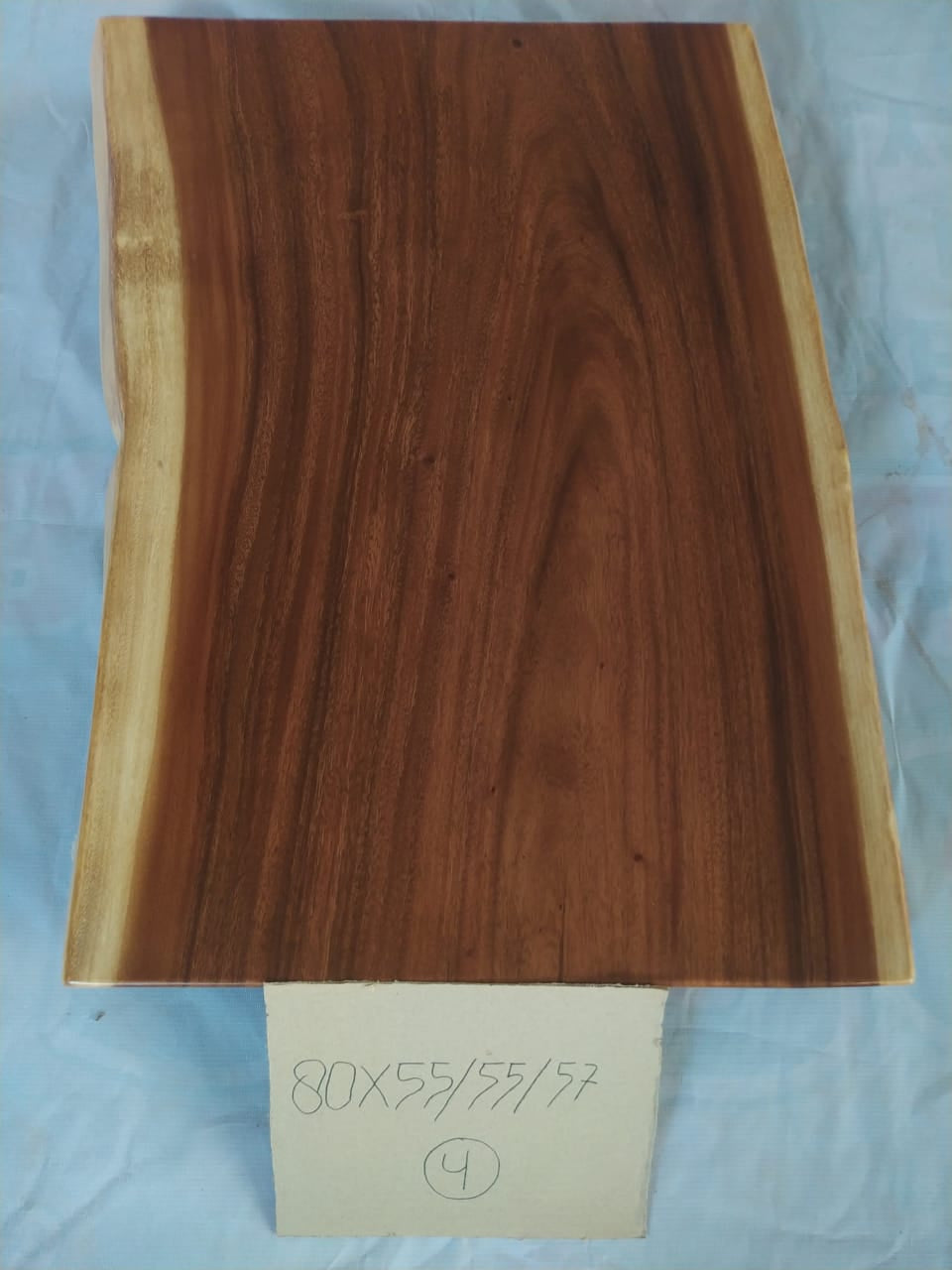 Top view of suar wood slab 0004-555557 with live edge shape and rich brown natural wood grain, solid single-piece countertop.
