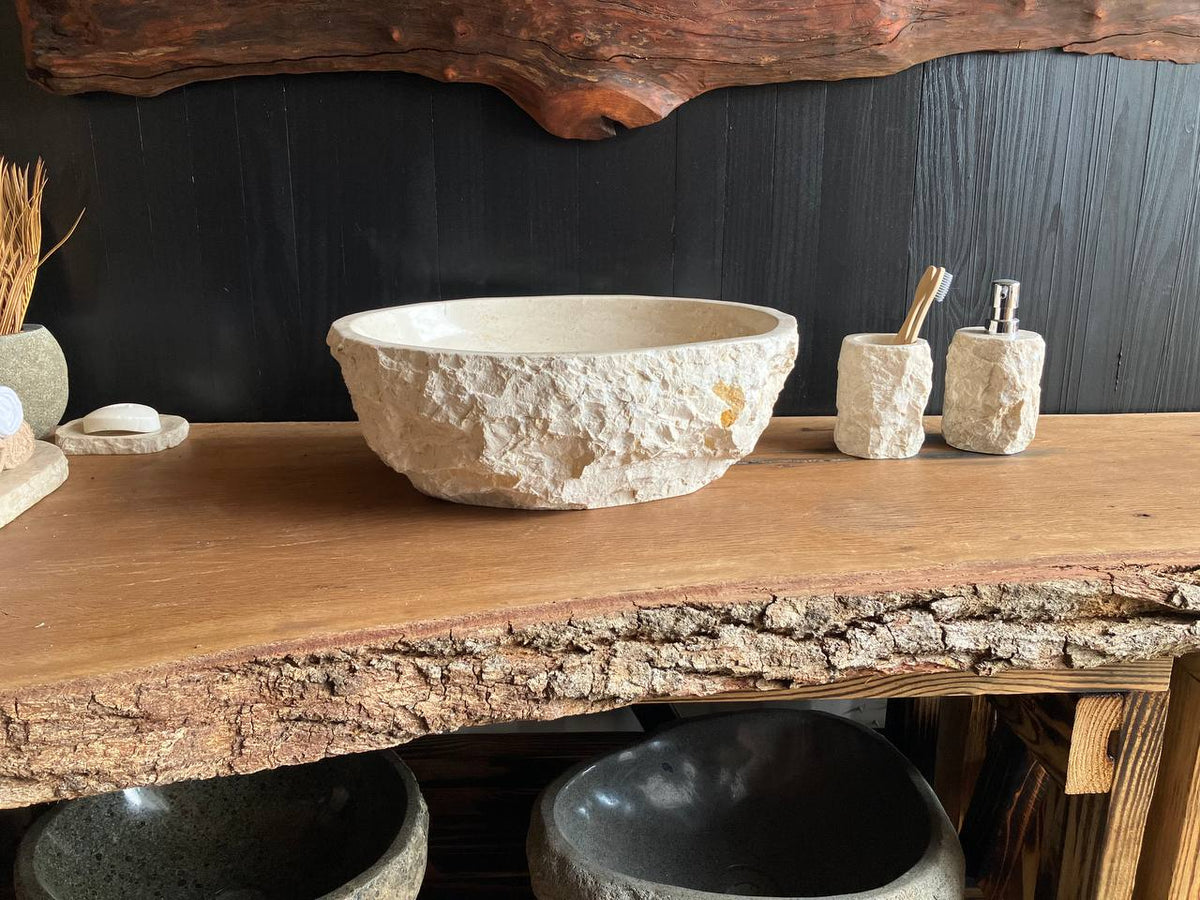 Beige marble vessel sink BMS-001 with a polished oval basin and subtle natural veining on a wood countertop