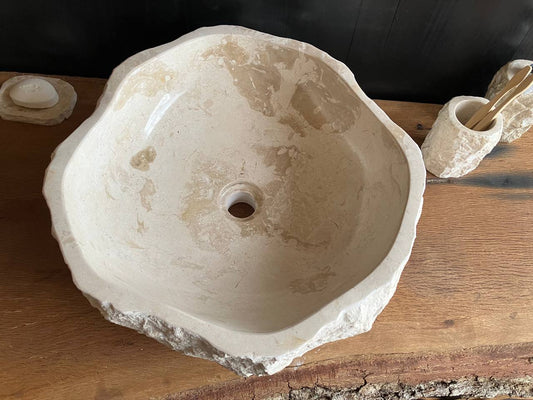 Natural beige marble bathroom vessel sink BMS-003 showing its rough chiseled exterior and irregular outline