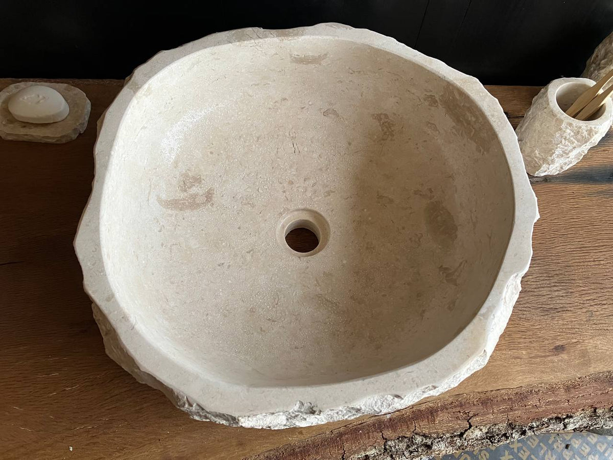 Natural beige marble bathroom vessel sink BMS-005 showing its rough chiseled stone exterior