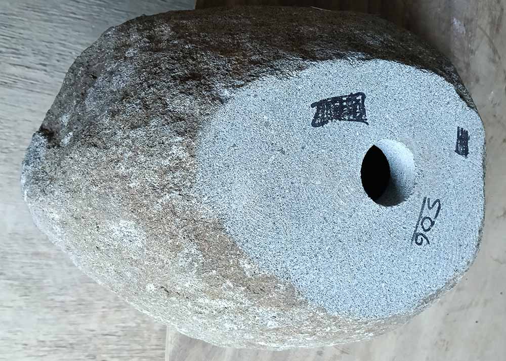 Bottom of natural sink 6506-4632 with rough stone base and drain hole
